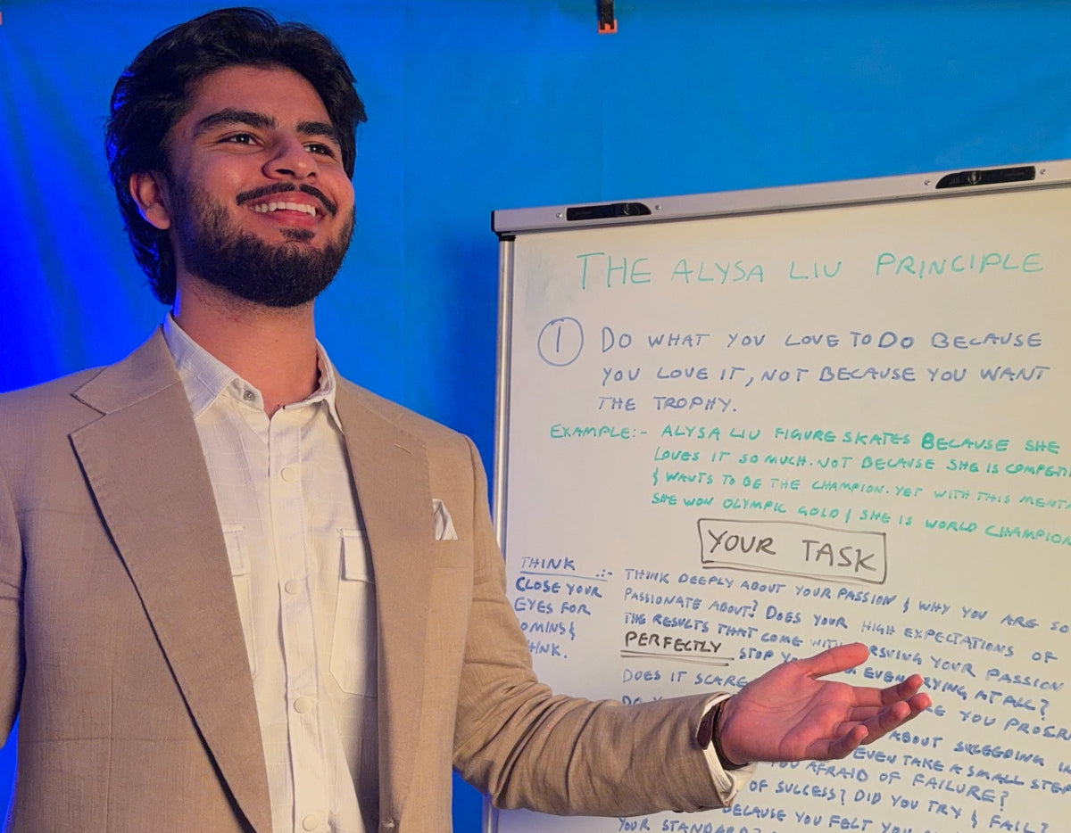 Muhammad Isaac explaining a concept to a student, both laughing